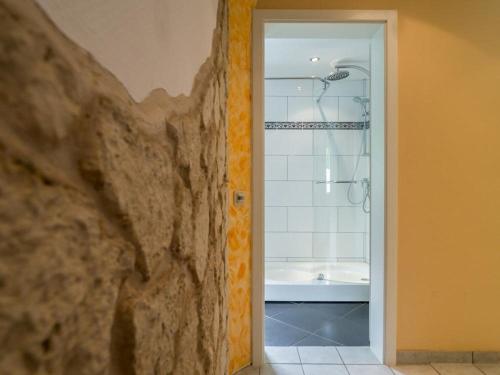 a bathroom with a shower and a tub at Naturferienhaus mit Schlossblick in Drübeck in Drübeck