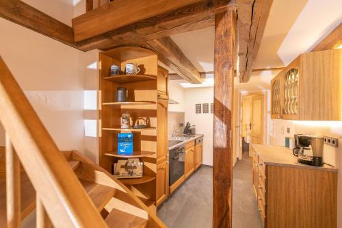 a kitchen with wooden stairs in a house at Villa-Duck-Dich 27 in Wernigerode