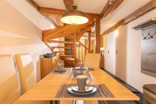 a dining room with a long table with cups on it at Villa-Duck-Dich 27 in Wernigerode