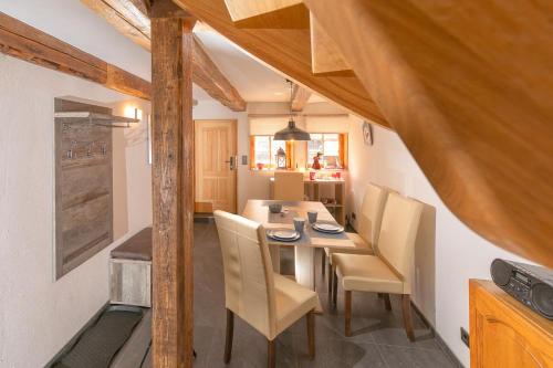 a kitchen and dining room with a table and chairs at Villa-Duck-Dich 27 in Wernigerode