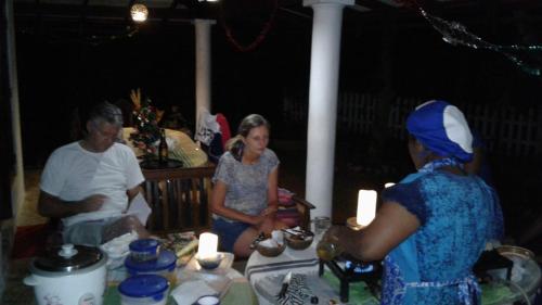 a group of people sitting around a table with candles at Style Villa in Bentota