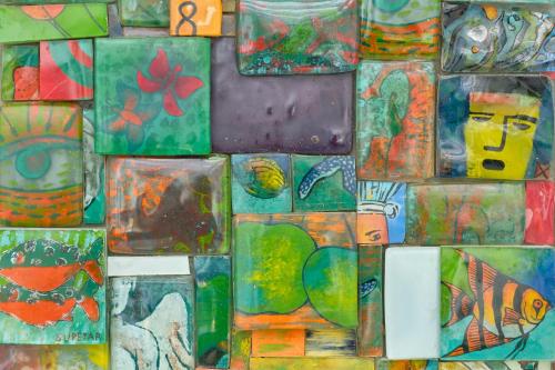 a collage of different types of art on a wall at La Via del Porto Charme Rooms in Agropoli