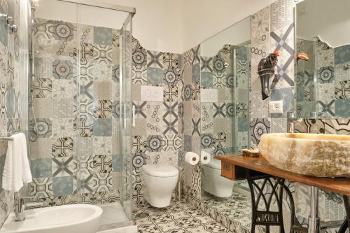 a bathroom with a sink and a toilet and a shower at La Via del Porto Charme Rooms in Agropoli