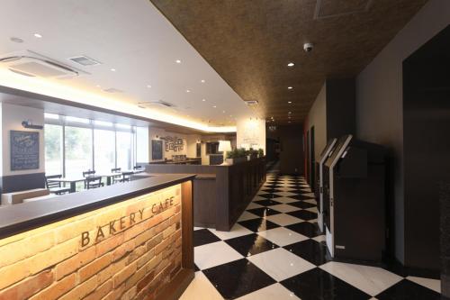 a restaurant with a black and white checkered floor at The Celecton Tsuchiura Ekimae in Tsuchiura