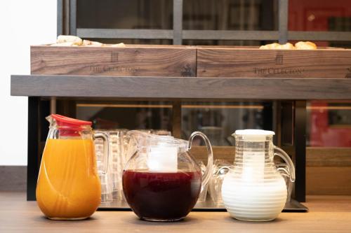 a table with two bottles of juice and two glass containers at The Celecton Tsuchiura Ekimae in Tsuchiura