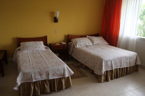 Cama o camas de una habitación en Hotel Bachue Girardot