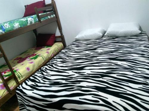 En eller flere senge i et værelse på Residencial Fênix