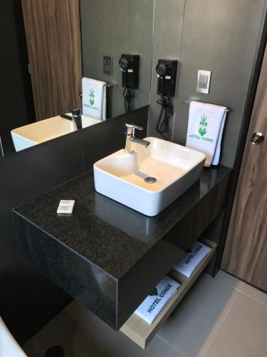 a bathroom with a sink and a mirror at Hotel Conde Alameda CDMX in Mexico City