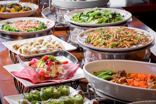 a table with many different types of food in trays at Hotel Hakuba in Hakuba