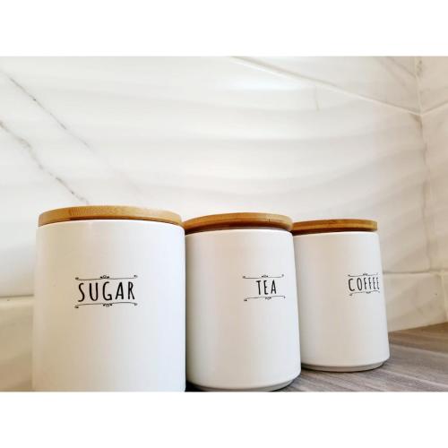 three white coffee cups sitting on a shelf at Waterfall Bed & Breakfast in Midrand