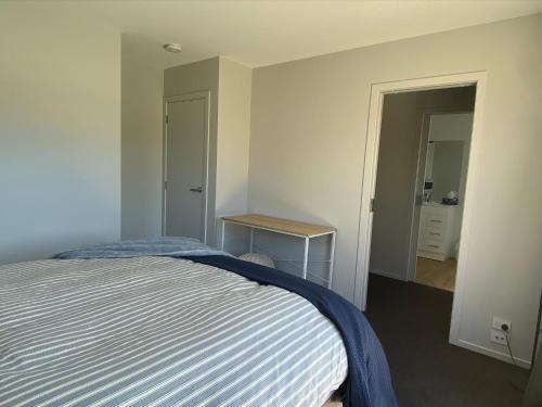 a bedroom with a bed and a table in it at Central Retreat and self contained with free wifi in Cromwell