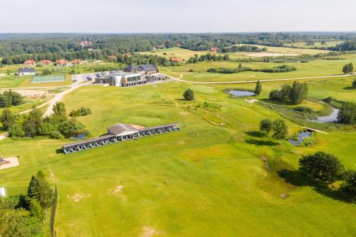 an aerial view of a large house on a green field at Apartamenty Mazurskie Klimaty (Cud Natury) in Tomaszkowo