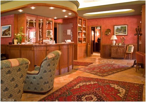 a lobby with a bar with chairs and a counter at Hotel Pesek in San Dorligo della Valle