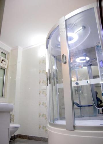 a glass shower in a bathroom with a sink at Hotel Home Stay Dwarka in New Delhi