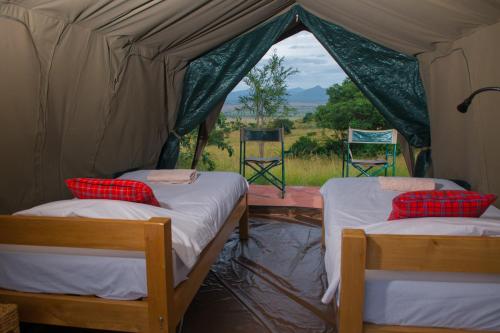 Un pat sau paturi într-o cameră la Kidepo Savannah Lodge by NATURE LODGES LTD