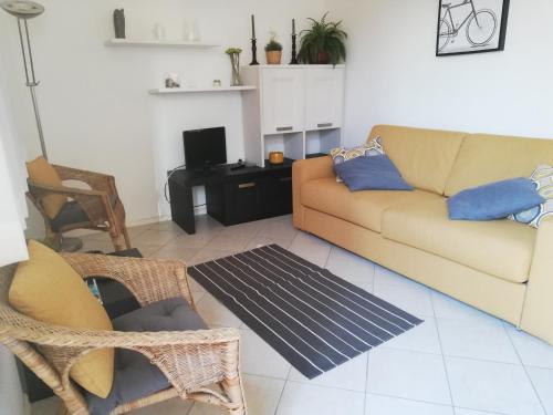 a living room with a couch and a table at residence Apuane in Cinquale