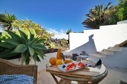 a tray of fruit on a table on a patio at B&B La Mimosa in Teguise