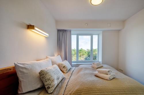 1 dormitorio con 1 cama con toallas en FeWo Prora - Meerestraum, en Binz