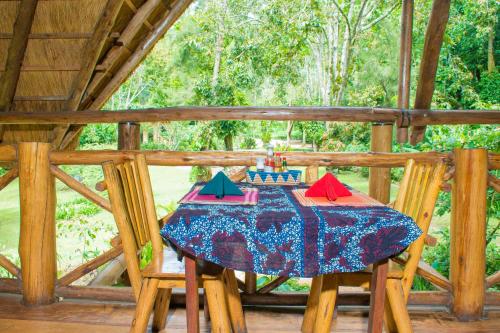 a table with a birthday cake on top of it at Kibale Forest Camp by NATURE LODGES LTD in Kyenjojo
