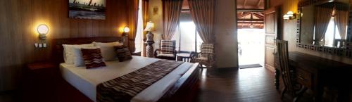 a bedroom with a bed and a door to a room at Nilaveli Beach Resort - Level 1 Certified in Nilaveli