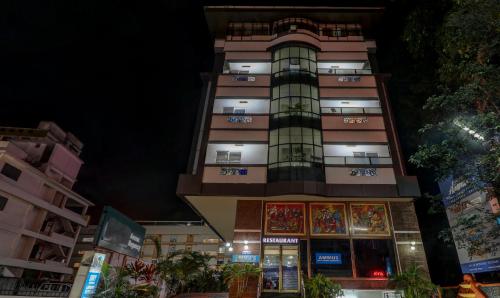 um edifício alto à noite com luzes acesas em Itsy By Treebo - Ammu Regency em Thrissur