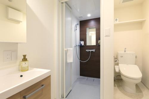 a bathroom with a toilet and a sink and a shower at Residence Hotel Hakata 19 in Fukuoka