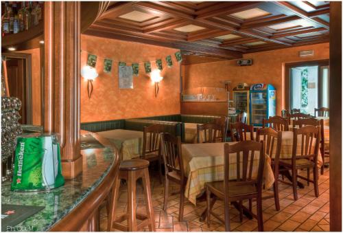 restauracja z barem, stołami i krzesłami w obiekcie Hotel Pesek w mieście San Dorligo della Valle