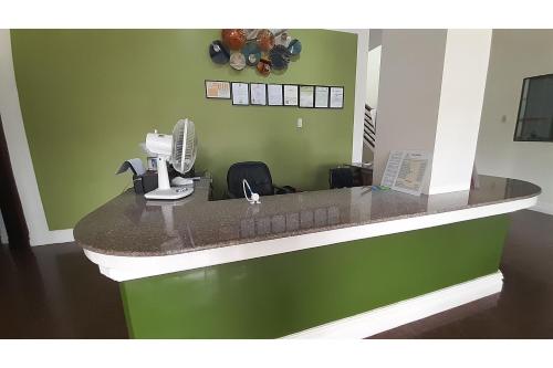 a kitchen with a counter with a hair dryer at Adelaida Pensionne Hotel in Bantayan Island