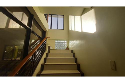 a staircase in a building with a stair case at Adelaida Pensionne Hotel in Bantayan Island