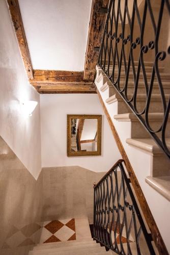 a stairwell with a mirror on the wall and a mirror at Anzolo Palace - Rooms & Apartments in Venice