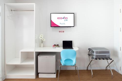 a white desk with a blue chair in a room at Eco Inn Lite Chanthaburi in Chanthaburi