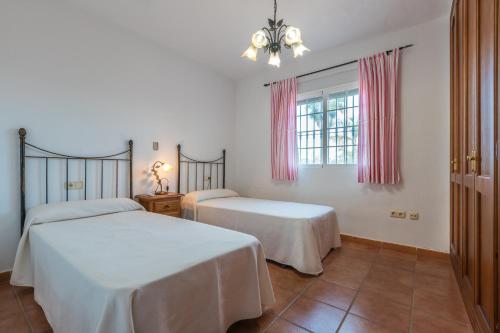 เตียงในห้องที่ Chalet andaluz Los Alberos