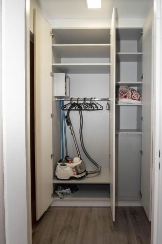 a walk in closet with white walls and shelves at Strasbourg Appart Cosy Hyper Centre in Strasbourg