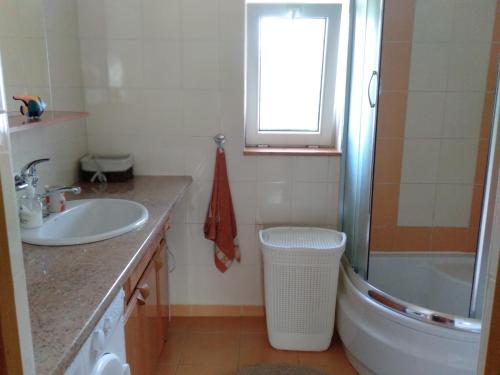 a bathroom with a sink and a toilet and a tub at Dwa jeziora in Wejsuny
