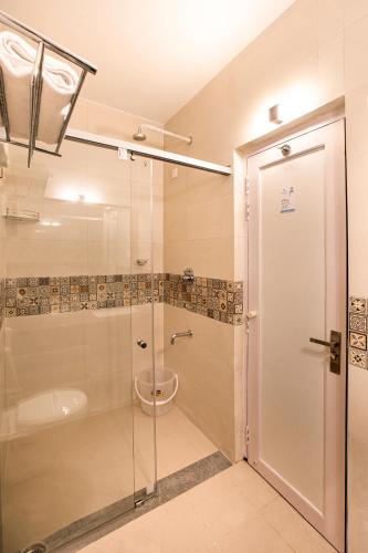 a bathroom with a shower and a toilet in it at Hotel Raindrops in Kodaikānāl