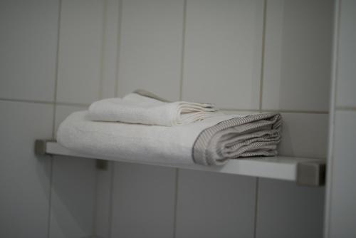 a towel sitting on a shelf in a bathroom at Tokeryds Herrgård in Jönköping
