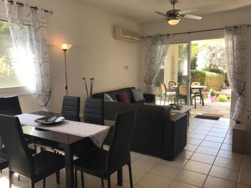 a living room with a table and a couch at Tala Hills Sea view apartment in Paphos City