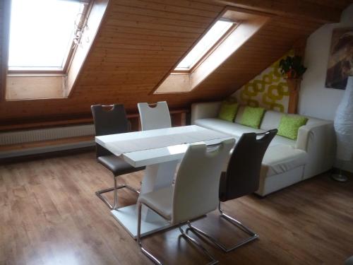 a living room with a table and chairs and a couch at Pension Pugner in Vysoké nad Jizerou
