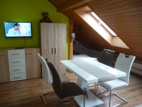 a dining room with a white table and chairs at Pension Pugner in Vysoké nad Jizerou
