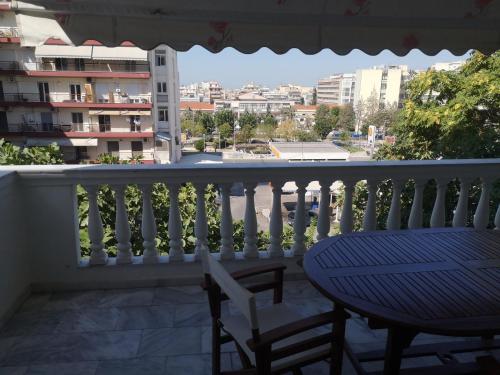 a balcony with a table and chairs and a view of a city at Comfortable Apartment in Kato Toumpa in Thessaloniki