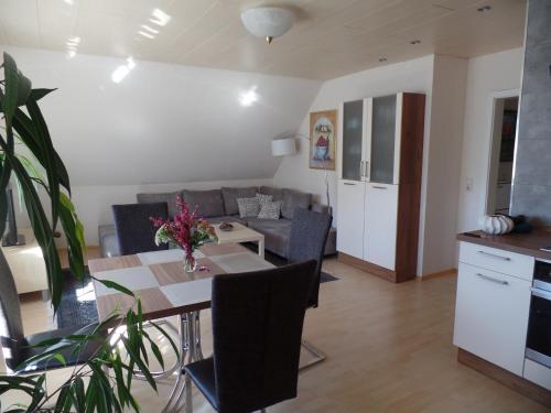 a kitchen and living room with a table and a couch at Logis Am Park in Dessau