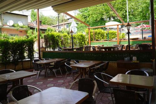 un restaurant vide avec des tables et des chaises en bois dans l'établissement İHVA HOTEL PİERRELOTİ, à Istanbul