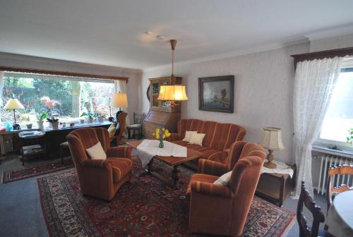 a living room with chairs and a couch and a table at Ferienhaus Hermann, 35522 in Uplengen