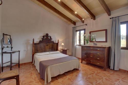 una camera con letto, cassettiera e finestra di YupiHome Finca S'Erissal de Costitx a Costitx