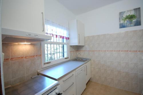 a kitchen with a sink and a counter top at YupiHome Holiday Home Kety in Portals Nous