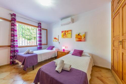 a room with two beds and a window at Finca Can Lluc in Alaró