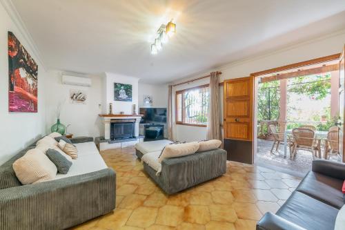 a living room with two couches and a fireplace at Finca Can Lluc in Alaró