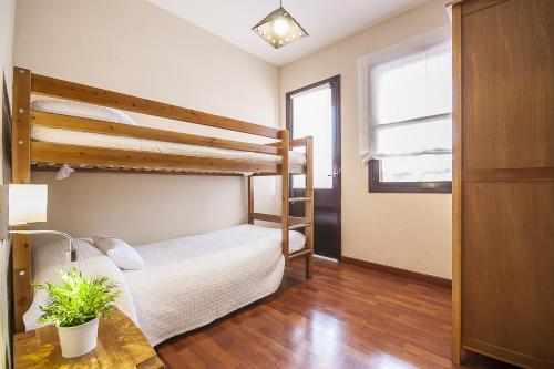 a bedroom with two bunk beds and a table at Finca Sa Reconada de L'Ullastre - Family only in Algaida