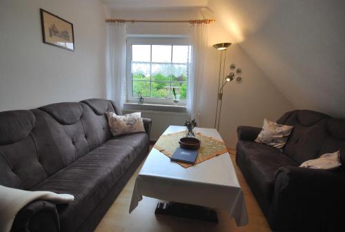 a living room with a couch and a coffee table at Ferienwohnung Hörnmoor, 35586 in Uplengen