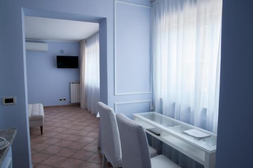 a room with a table and chairs and a window at Villa Le Terrazze Charming Rooms in Taormina